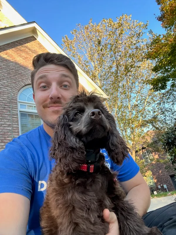 Dog Owner’s Academy trainer Dom with Trace, a high-energy dog who became calmer and better mannered through in-home dog training lessons.